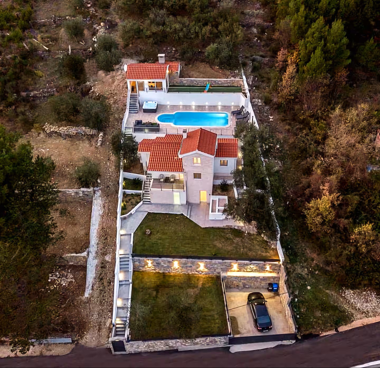 Evening drone view of the full villa estate